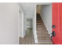 Inviting entryway with stairs, light gray walls, wood-look flooring and a bright white trim at 5408 Gunnette Dr, Raleigh, NC 27610