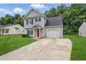 Charming two-story home featuring a well-manicured lawn, a bright red front door, and an attached one-car garage at 5408 Gunnette Dr, Raleigh, NC 27610