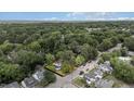 Aerial view of property surrounded by lush greenery and a neighborhood at 830 S Chestnut St, Henderson, NC 27536