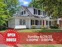 Charming two-story traditional home featuring black shutters, lush green lawn and Open House banner at 830 S Chestnut St, Henderson, NC 27536