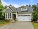 Charming home with a gray exterior, well-kept lawn, and two-car garage at 850 Apalachia Lake Dr, Fuquay Varina, NC 27526