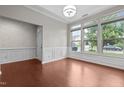 Bright and airy room with wainscoting, hardwood floors, and multiple windows at 850 Apalachia Lake Dr, Fuquay Varina, NC 27526