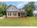 Charming brick home with manicured lawn, inviting curb appeal and craftsman details at 90 Starwood Dr, Garner, NC 27529