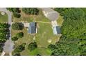 This aerial view showcases the home, a detached garage, and the surrounding lush greenery and spacious lot at 102 Ridge Ln, Youngsville, NC 27596