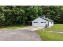 Spacious detached garage with ample parking, featuring dual doors and a well-maintained exterior, nestled in a green landscape at 102 Ridge Ln, Youngsville, NC 27596