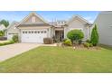 Charming single-Gathering home with a well-manicured lawn, attractive landscaping, and a two-car garage at 104 Spindle Dr, Durham, NC 27703