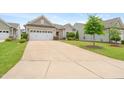 Charming single-Gathering home with a well-manicured lawn, attractive landscaping, and a two-car garage at 104 Spindle Dr, Durham, NC 27703