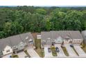 Aerial view of townhomes with lush landscaping and a tree-lined backdrop at 1048 Flagler St, Durham, NC 27713