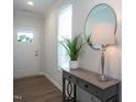 Inviting entryway featuring a stylish console table, decorative mirror, and a white front door at 1048 Flagler St, Durham, NC 27713