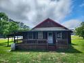 Rustic one-story house featuring a cozy front porch and a well-maintained lawn at 111 Matthews Mill Pond Rd, Angier, NC 27501