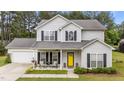 Charming two-story home with light siding, black shutters and a bright yellow front door at 11233 Jeffreys Ln, Wake Forest, NC 27587