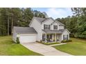 Two-story home with attached garage, well-manicured lawn, and inviting front porch at 11233 Jeffreys Ln, Wake Forest, NC 27587