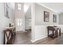 Welcoming foyer with high ceilings, elegant lighting, and beautiful dark wood floors at 1211 Whispering Oak Ln, Durham, NC 27704