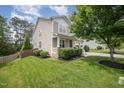 Well-maintained lawn and landscaping along side of house, showing good curb appeal and property size at 1211 Whispering Oak Ln, Durham, NC 27704