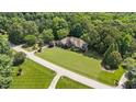 A sprawling property with mature trees surrounds this stately home creating a private retreat at 12504 Bayleaf Church Rd, Raleigh, NC 27614
