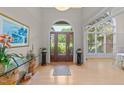 Elegant foyer features a stunning front door, wood floors, and grand ceilings offering a warm welcome at 12504 Bayleaf Church Rd, Raleigh, NC 27614