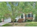 Charming brick home featuring a well-manicured lawn and mature trees in a desirable neighborhood at 1309 Caribou Xing, Durham, NC 27713