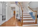 Grand foyer featuring hardwood floors, a staircase, and light neutral paint, creating a welcoming atmosphere at 1309 Caribou Xing, Durham, NC 27713