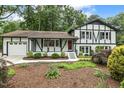 Charming two-story home with a landscaped front yard featuring Tudor-style architecture and covered porch at 1420 Seabrook Ave, Cary, NC 27511