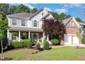 Charming two-story home featuring a brick and siding exterior, a two-car garage, and a beautifully landscaped front yard at 1603 Timber Wolf Dr, Durham, NC 27713
