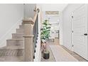 Inviting entryway with a staircase and decorative 'Home Sweet Home' decor, leading to kitchen at 18 Dot Dr, Wendell, NC 27591