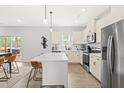 Bright, modern kitchen with stainless steel appliances, a large island, and open layout to living area at 18 Dot Dr, Wendell, NC 27591