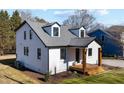 Angle view of the home showcasing the landscaped yard, dormer windows, and architectural details at 18 W Academy St, Wendell, NC 27591