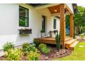 Covered porch with recessed lighting, flower boxes and wood ceiling is ready for relaxing at 18 W Academy St, Wendell, NC 27591