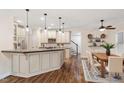 Open-concept kitchen featuring an island with bar seating, modern appliances, and wood floors at 1817 Foxbrook Dr, Raleigh, NC 27603