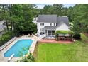 Backyard with a large swimming pool, patio, and screened-in porch at 1817 Foxbrook Dr, Raleigh, NC 27603
