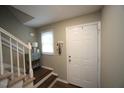 Inviting foyer with stairs, white trim, and a convenient entry to the home at 1910 Trexler Ct, Raleigh, NC 27606