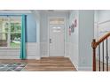 Bright entryway features hardwood floors, wainscoting, and a stylish front door at 1939 Mostyn Ln, Apex, NC 27502