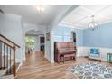 Inviting living room features an open floor plan and an elegant piano at 1939 Mostyn Ln, Apex, NC 27502