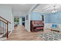 Open-concept living area with hardwood floors and an elegant archway at 1939 Mostyn Ln, Apex, NC 27502