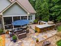 Outdoor kitchen with a stone counter and barbecue, perfect for entertaining at 201 Margaret Mann Way, Pittsboro, NC 27312