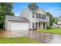 Charming two-story home with a well-manicured lawn, attached garage, and inviting yellow front door at 202 Stonecreek Dr, Apex, NC 27539
