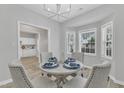 Elegant dining room with ample natural light and seating for four guests at 220 Misty Groves Cir, Morrisville, NC 27560