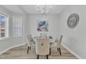 Elegant dining room with a round table, upholstered chairs, modern lighting, and tasteful decor creates a cozy setting at 220 Misty Groves Cir, Morrisville, NC 27560