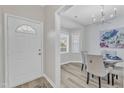 Bright dining area features a chandelier, wood flooring, and a charming bay window for delightful meals at 220 Misty Groves Cir, Morrisville, NC 27560