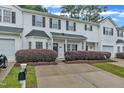 Inviting exterior view of a townhome showcasing tidy landscaping and a convenient driveway, offering pleasant living space at 220 Misty Groves Cir, Morrisville, NC 27560
