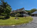 Charming home with a spacious wraparound porch, offering serene views of the lush surrounding greenery at 2371 Nc 210, Smithfield, NC 27577