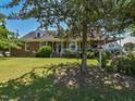 Quaint brick home featuring a covered front porch, perfect for enjoying the landscaped front yard at 2371 Nc 210, Smithfield, NC 27577