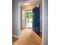 Bright foyer with hardwood floors and a welcoming blue front door at 2532 Rolling Meadows Dr, Raleigh, NC 27603