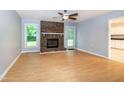 Spacious living room features a cozy brick fireplace and plenty of natural light at 2532 Rolling Meadows Dr, Raleigh, NC 27603