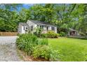 Charming home featuring flowering plants, gravel driveway, and lovely curb appeal at 26 Rogerson Dr, Chapel Hill, NC 27517