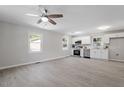 Open-concept living room and kitchen with modern gray flooring and stainless appliances at 2612 Glenbrook Dr, Durham, NC 27704