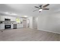 Spacious living area flows into a modern kitchen with white cabinets and stainless appliances at 2612 Glenbrook Dr, Durham, NC 27704