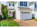 Well-maintained home featuring a garage, an American flag, and lovely landscaping on a sunny day at 2635 Asher View Ct, Raleigh, NC 27606