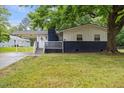 Charming home featuring a covered entrance, dark brick accents and a well maintained lawn at 2752 Weldon Ter, Durham, NC 27703