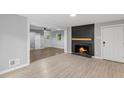 Bright living room with fireplace, hardwood floors, and an open doorway to another room at 2752 Weldon Ter, Durham, NC 27703